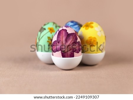 Multicolored wooden Easter egg decorated with pressed dried flowers. Fashion spring colors. Art ideas for Easter. Royalty-Free Stock Photo #2249109307