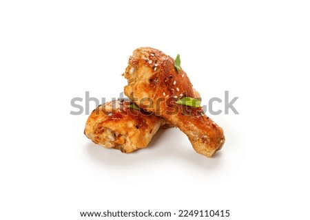 Roasted Baked chicken legs drumsticks, chicken meat with sesame seeds isolated on white background with clipping path, cut out. Royalty-Free Stock Photo #2249110415
