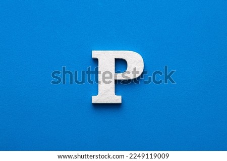 Alphabet letter P - White wooden letter on blue foamy background