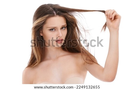 Portrait, hair and fail with a model woman in studio on a white background holding split ends in frustration. Face, haircare and unhappy with a young female feeling negative about her hairstyle