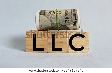 Limited liability company. LLC the word on wooden cubes, cubes are on a white background. Business and finance concept