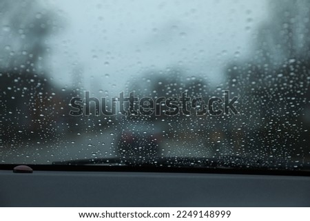 raindrop raining on car window droplets gloomy day 