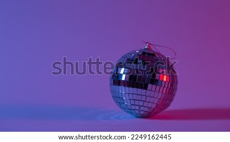 Disco ball in neon lighting isolated, concept of party, disco and dancing, copy space.