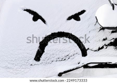 Snow face on the car window with copy space. High quality photo