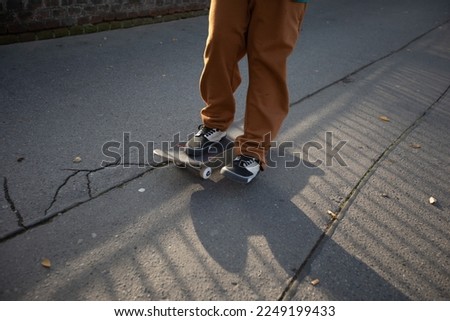 Teenager skateboarding. Skateboarder legs close up. Boy girl rides a skateboard. Balancing on a skateboard. Tricks