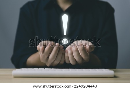 businessman hand showing exclamation point business development ideas Warning of errors, dangers, alerts, maintenance, And finding solutions. Important information. Dark background with copy space.