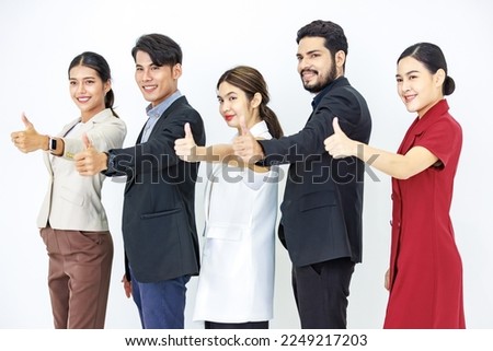 Studio shot Asian Indian male female professional successful businessmen and businesswomen group in formal suit standing in line posing crossed arms holding hands in pants pocket on white background.