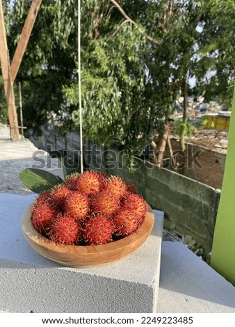 fresh rambutan in wooden baskets harvested from the garden