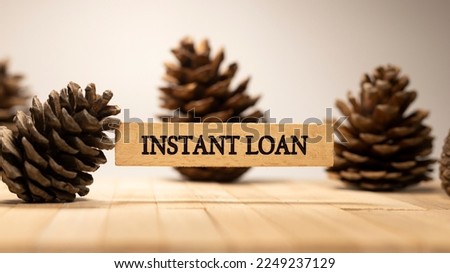 Instant loan text. It is written on a wooden surface. The background is white