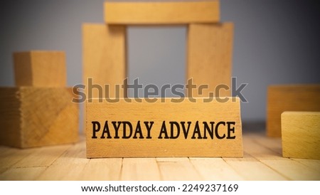 Payday Advance text. It is written on a wooden surface. The background is white