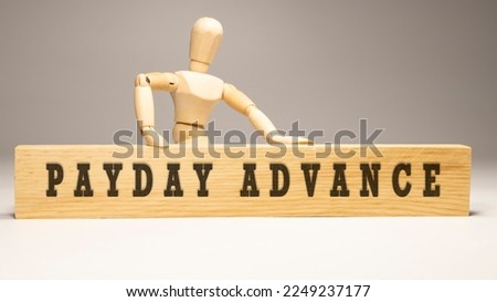 Payday Advance text. It is written on a wooden surface. The background is white