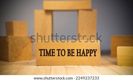Time to be happy text. It is written on a wooden surface. The background is white