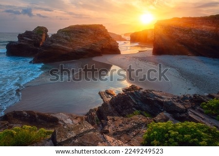 Cathedrals beach (Playa de las Catedrales) or Praia de Augas Santas at sunrise, amazing landscape with rocks on the Atlantic coast and colored sky, Ribadeo, Galicia, Spain. Outdoor travel background Royalty-Free Stock Photo #2249249523