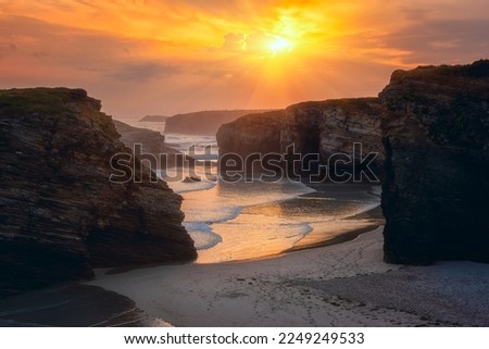 Cathedrals beach (Playa de las Catedrales) or Praia de Augas Santas at sunrise, amazing landscape with rocks on the Atlantic coast and colored sky, Ribadeo, Galicia, Spain. Outdoor travel background Royalty-Free Stock Photo #2249249533
