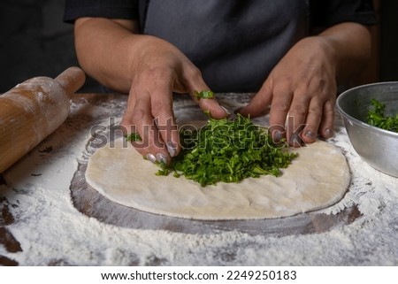 chef making dough with flour and herbs