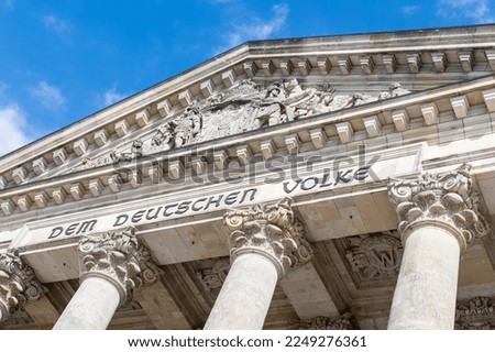 The Reichstag building (Bundestag) in Berlin, Germany, meeting place of the German parliament: The inscription says: Dem Deutschen Volke - To the German people Royalty-Free Stock Photo #2249276361