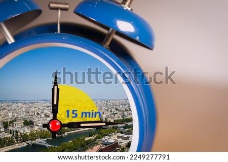 Ringing twin bell vintage classic alarm clock with the 15 minute city concept. Royalty-Free Stock Photo #2249277791
