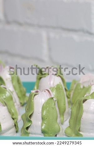 Homemade zephyr tulips dry on a tray. On a white background. Close-up.