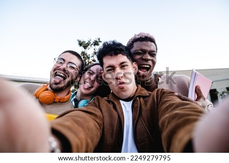 Happy diverse friends taking selfie