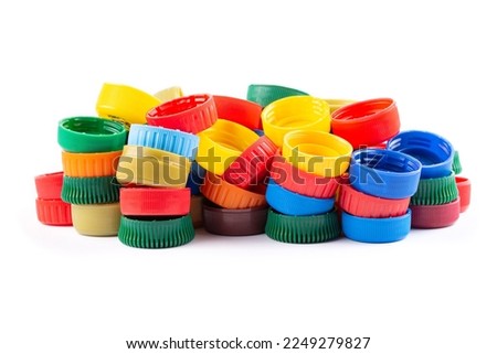 Different color bottle caps, excellent raw material for recycling. Composition with plastic bottles and caps isolated on white. Royalty-Free Stock Photo #2249279827