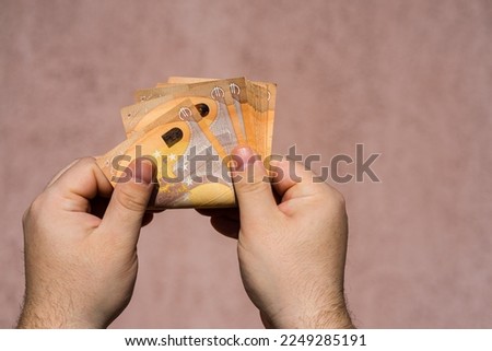 Hand couting holding and showing euro money or giving money. World money concept, 50 EURO banknotes EUR currency isolated with copy space. Concept of rich business people, saving or spending money.