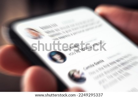 Controversy, online anger and troll or hate comment on social media. Debate, fight and bad dialog on news feed. Cyber bully and hater posting mean negative message. Reading mobile phone screen. Royalty-Free Stock Photo #2249295337