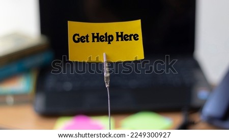 Concept of New Beautiful  Get help here symbol, Get help here symbol written on a card at the office.Business and get help here concept.