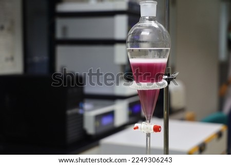 separating natural product use dichloromethane with water have two layer colorful and white in separating funnel is drug research  process Royalty-Free Stock Photo #2249306243