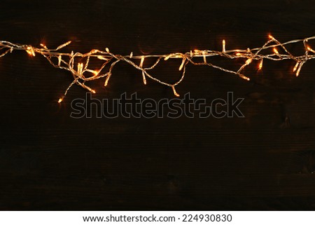 Christmas lights on wooden background