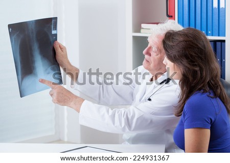 Experienced doctor analyzing x-ray of the lungs Royalty-Free Stock Photo #224931367