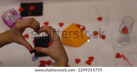 A heart from the hands. red paper hearts. Romantic mood. The 14th of February.Valentine's day. A declaration of love.