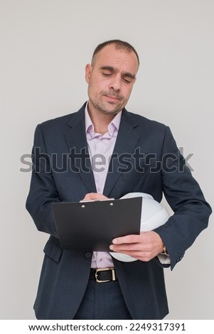 male architect or foreman in a gray business suit on the background. High quality photo