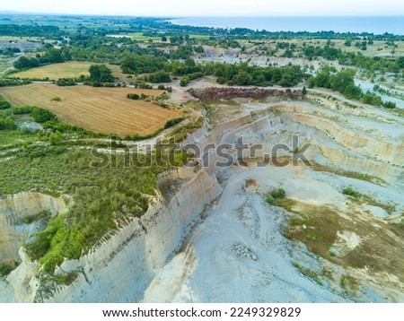 Sand craters in Montenegro and modern equipment and machines for the extraction of sand against the backdrop of mountains