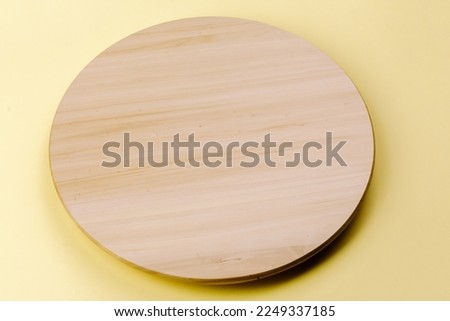 Wooden round board on the table.