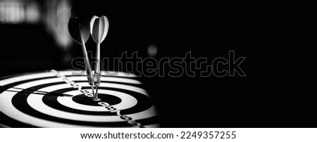 Bullseye target goal or dartboard has dart arrow throw hitting center shooting for financial business targeting planning to winner concept. Royalty-Free Stock Photo #2249357255