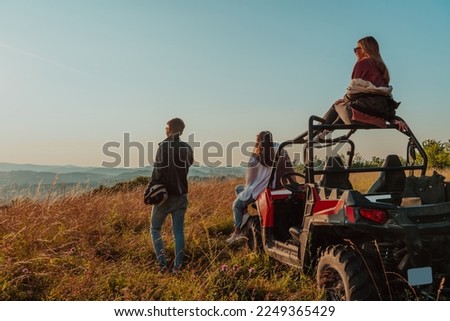 Group young happy people enjoying beautiful sunny day while driving a off road buggy car on mountain nature Royalty-Free Stock Photo #2249365429