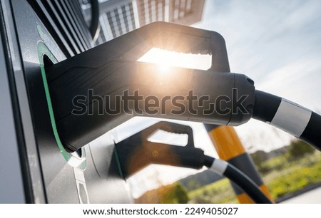 Modern fast 300KW Hypercharger or Supercharger for electrical or hybrid PHEV automobiles with DC CCS type 2 EV charging connector at EV charging station. Charge for electromobility concept image. Royalty-Free Stock Photo #2249405027