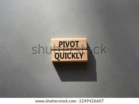 Pivot quickly symbol. Wooden blocks with words Pivot quickly. Beautiful grey background. Business and Pivot quickly concept. Copy space.