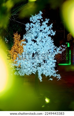   bokeh effect with plastic trees illuminated with led lights. night decoration at Bogota planetarium in Colombia. plastic trees illuminated with led bulbs in the middle of the park.                  