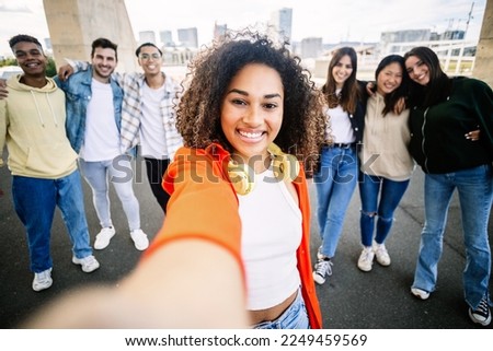 University student friends taking selfie portrait together at campus college. United diverse teenage people posing for group photo. Community and diversity concept