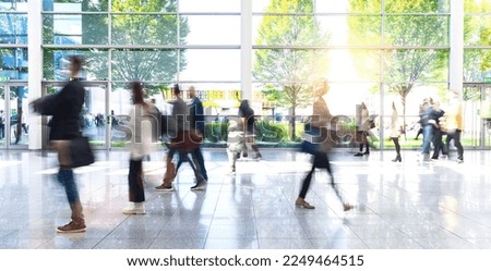 Anonymous crowd goes by trade fair or airport through a corridor Royalty-Free Stock Photo #2249464515