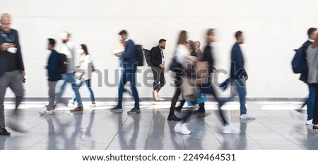 Many anonymous people walk in a corridor from the mall Royalty-Free Stock Photo #2249464531