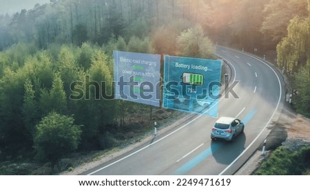 wireless electric vehicle charging while driving on road charging system. Royalty-Free Stock Photo #2249471619