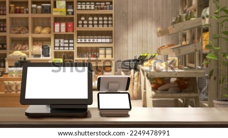 Cash register with blank computer monitor screen, white touchscreen tablet on wooden counter in cozy, luxury organic, eco-friendly bakery grocery store with shelf, product display in background 3D