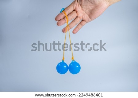 Lato-lato is a type of traditional game that can be found in Indonesia. Isolated on white background.