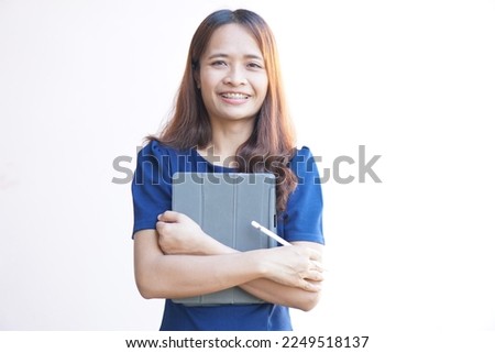 Asian woman holding a portable computer in hand	