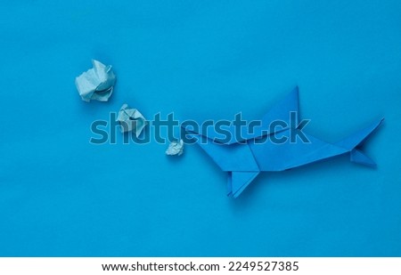 Origami shark on a blue background