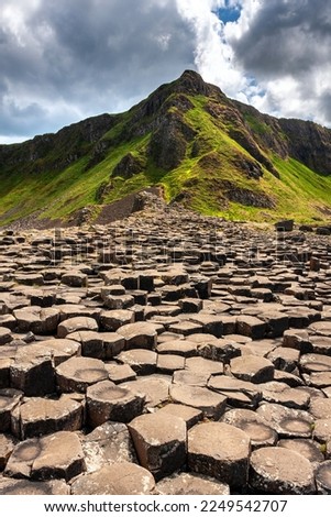 Giant's Causeway of Northern Ireland, Green hills and Basalt columns.
 Royalty-Free Stock Photo #2249542707