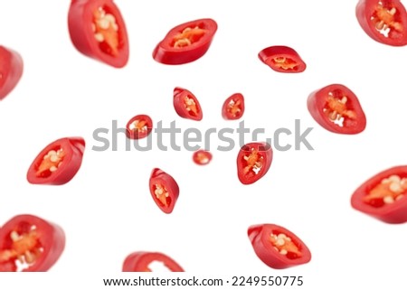 Falling sliced red hot chili peppers isolated on white background, selective focus Royalty-Free Stock Photo #2249550775