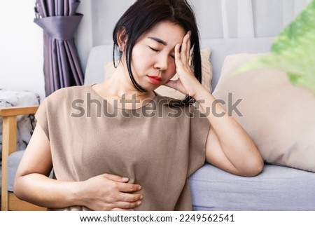 Gut-Brain Axis and anxiety concept with stress Asian woman have problems with digestion systems, stomachache, irritable bowel syndrome ( IBS)  Royalty-Free Stock Photo #2249562541
